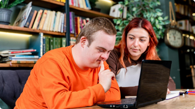 Young man and woman viewing a laptop computer